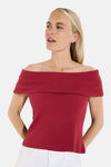 Red off-the-shoulder ribbed short-sleeve top with fitted silhouette, worn with white pants, front view