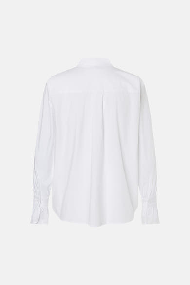 White long-sleeve blouse by MORE & MORE, back view with central pleat and ruffled cuffs