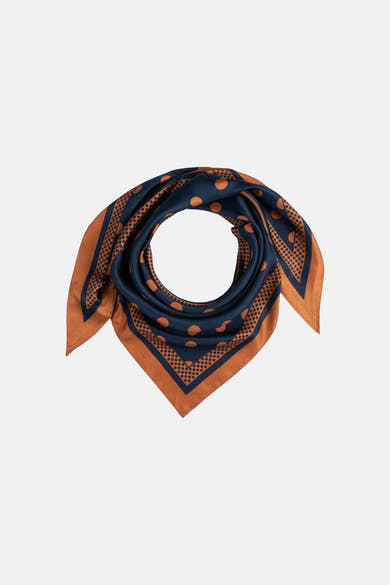 Multicolored silk foulard by MORE & MORE, navy with rust polka dots and dotted border, folded in circular display