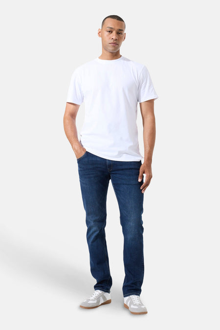 Jean droit bleu foncé de GARCIA, porté avec un t-shirt blanc et des baskets grises.