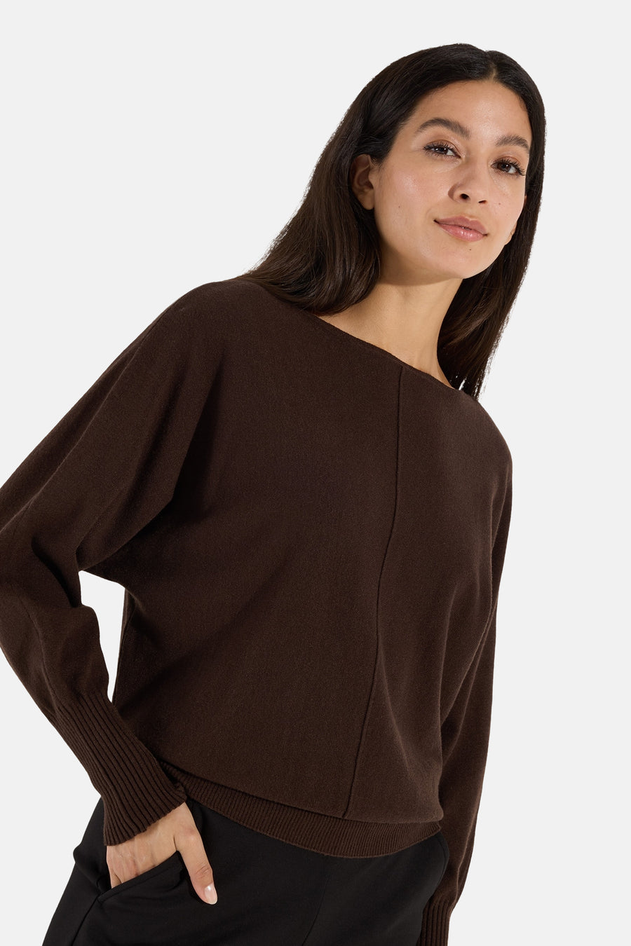 Brown round-neck sweater by MORE & MORE, featuring ribbed cuffs and hem, shown in side view on model with black pants.