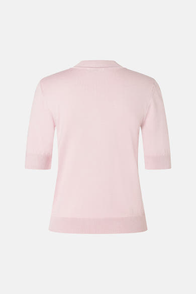 Soft pink ribbed knit turtleneck sweater by MORE & MORE, back view with three-quarter sleeves and clean silhouette.