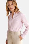 Pink and white striped long-sleeve blouse by MORE & MORE, featuring ruffled cuffs and a button-down front, shown on model in lifestyle pose.
