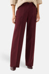 Burgundy wide-leg suit pants by MORE & MORE, featuring front pleats and a high waist, shown with beige sweater and dark brown shoes.