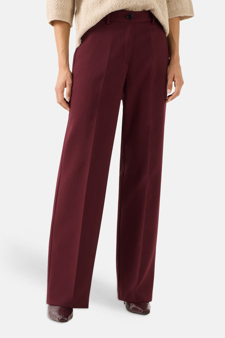 Burgundy wide-leg suit pants by MORE & MORE, featuring front pleats and a high waist, shown with beige sweater and dark brown shoes.