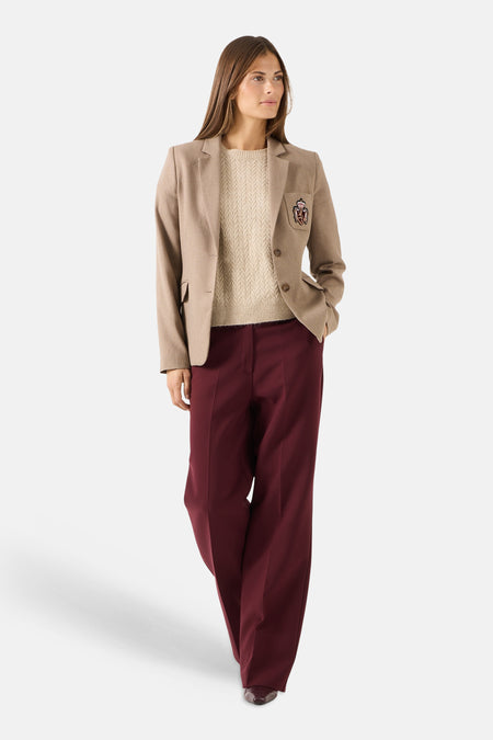 Burgundy wide-leg suit pants by MORE & MORE, worn with beige blazer and textured sweater, full-length front view