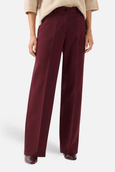 Burgundy wide-leg suit pants by MORE & MORE, featuring front pleats and a high waist, shown with beige sweater and dark brown shoes in front view.