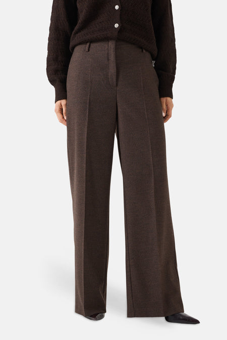 Brown wide-leg suit trousers by MORE & MORE, featuring front pleats and a textured wool-blend fabric, shown on model with dark sweater and pointed shoes.