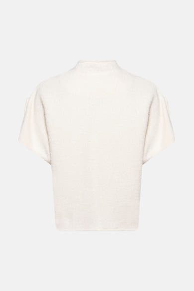 Cardigan écru de Terra di Siena, en maille bouclette texturée, avec des manches courtes amples.