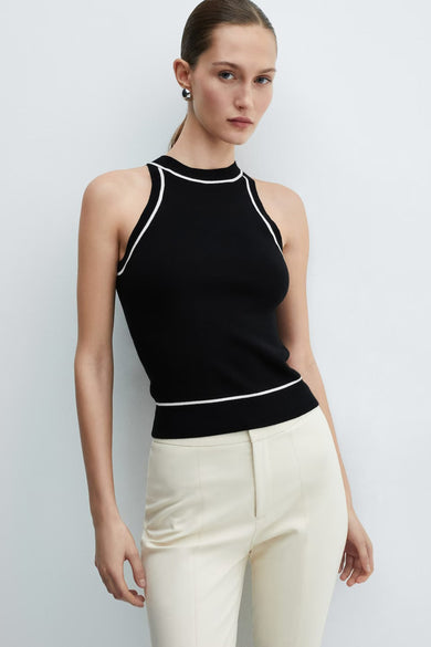 Black ribbed knit halter top with white contrast trim by MANGO, worn with cream trousers, front view