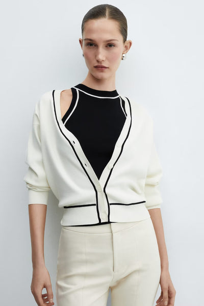 Black ribbed tank top with cutout shoulders by MANGO, worn under white cardigan with black trim, front view