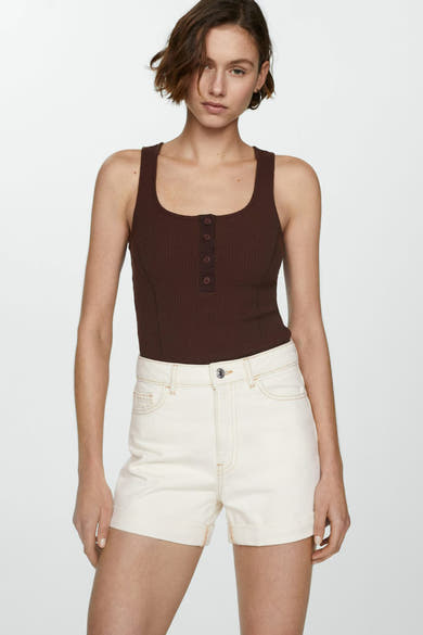 Korte beige short van MANGO, gedragen met een bruin hemdje met knopen en opgerolde zomen.