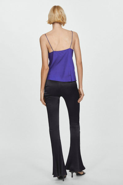Top bleu à fines bretelles de MANGO, porté avec un pantalon noir évasé et des talons aiguilles, vue de dos.
