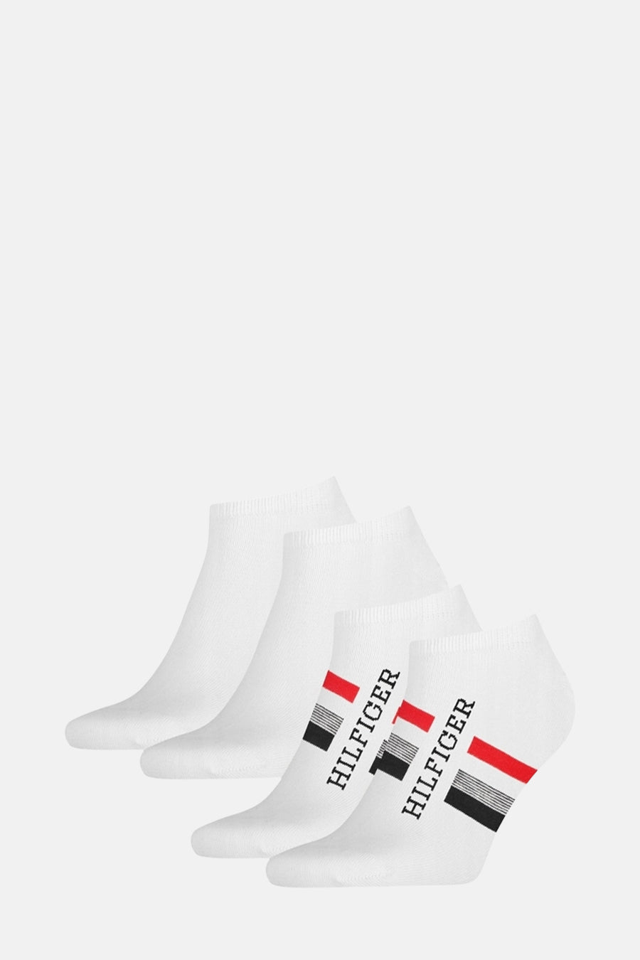 Chaussettes blanches par TOMMY JEANS avec rayures rouges et noires, logo Hilfiger imprimé sur le côté.
