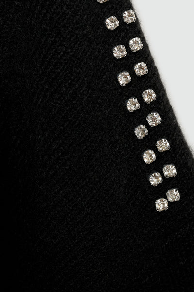 Pull à col rond noir de MANGO, orné de strass scintillants sur l'épaule et tricot texturé en laine.