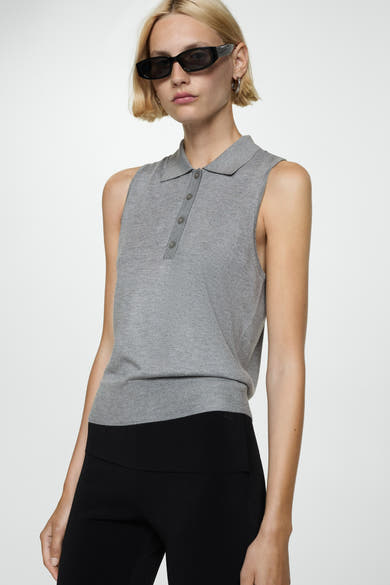 Bruin poloshirt van MANGO, mouwloos, gedragen met een zwarte pantalon met hoge taille, achterzijde.