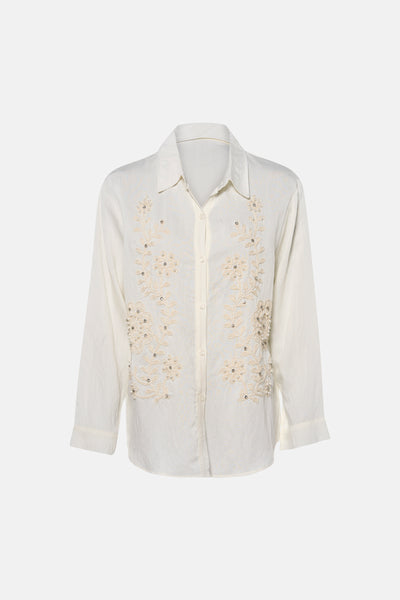 Beige long-sleeve blouse with floral embroidery and pearl embellishments, front view on mannequin