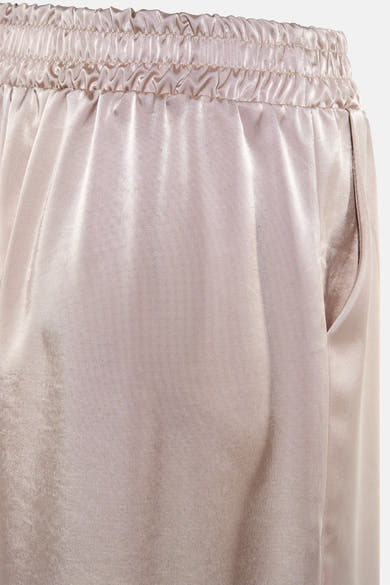 Pantalon beige de Terra di Siena avec taille élastique et une poche visible sur le côté.