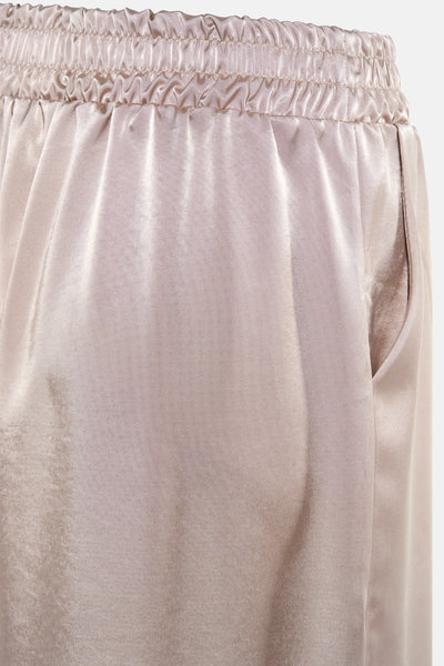 Pantalon beige de Terra di Siena avec taille élastique et une poche visible sur le côté.