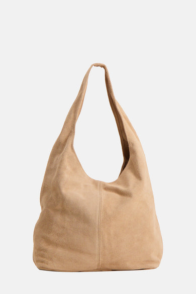 Ecru suede shoulder bag with soft slouchy design and single long strap, front view