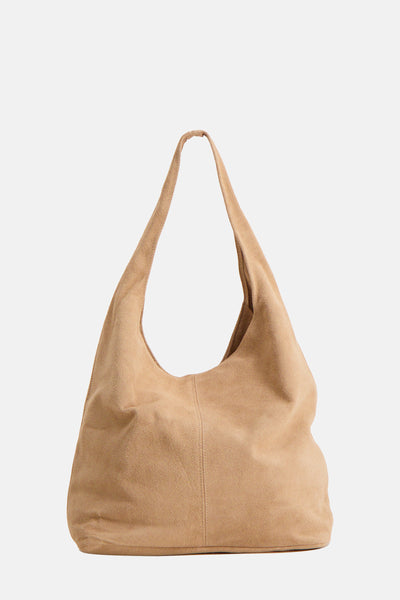 Ecru suede shoulder bag with soft slouchy design and long strap, front view
