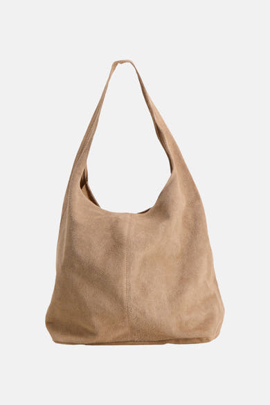 Taupe suede shoulder bag with soft slouchy design and single long strap, front view
