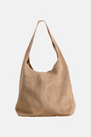 Taupe suede shoulder bag with soft slouchy design and single long strap, front view