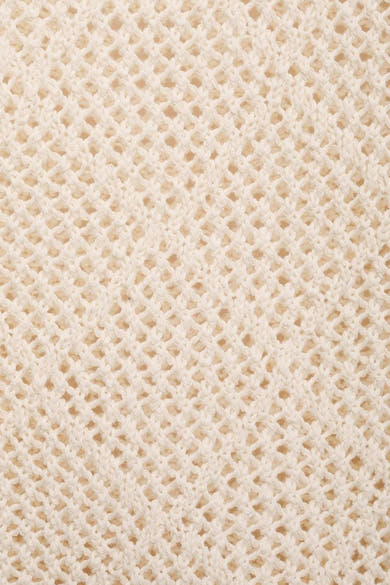Pull à col rond écru de MANGO, présentant une maille ajourée et une texture tricotée.
