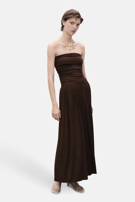 Bruine lange jurk van MANGO, bustier en geplooid model, gedragen met open sandalen met hak.