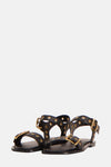 Sandales noires de MANGO avec brides à œillets dorés et boucles réglables.