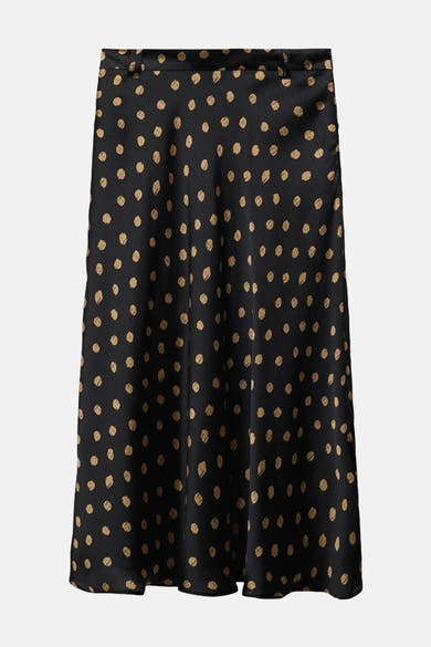 Zwarte lange rok met gouden stippen van MANGO, met een subtiel textuurpatroon.