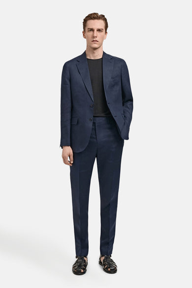 Blauwe blazer van MANGO, gedragen met een zwart T-shirt en een bijpassende broek, met zwarte sandalen.