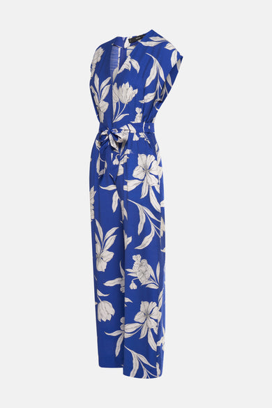 Blauwe jumpsuit met bloemenprint van MANGO, met een strikceintuur in de taille en een losse pasvorm.