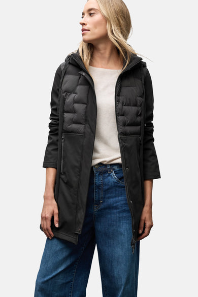 Veste longue noire de STREET ONE avec fermeture éclair, poches zippées et capuche, portée avec un t-shirt et un jean.
