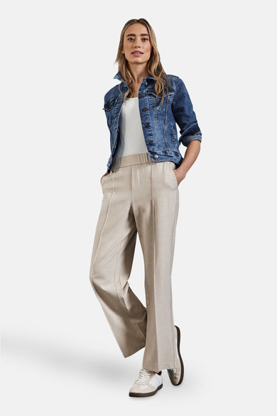Middelblauwe denim spijkerjas van Street One, gedragen met een witte tanktop en een beige broek.