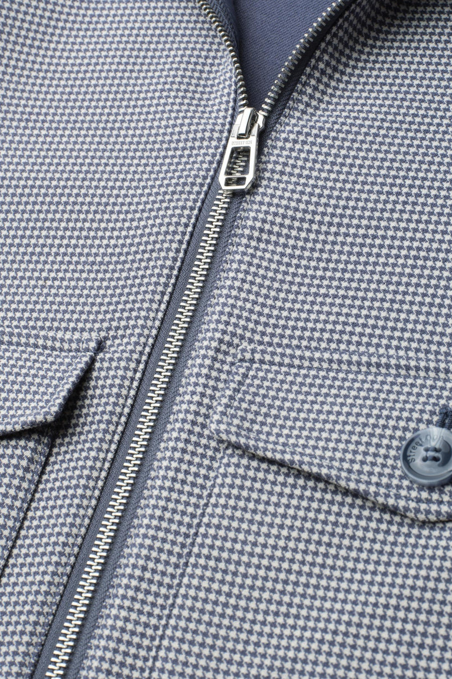 Blue houndstooth pattern casual jacket by Stree with silver zipper and flap pockets, close-up front view