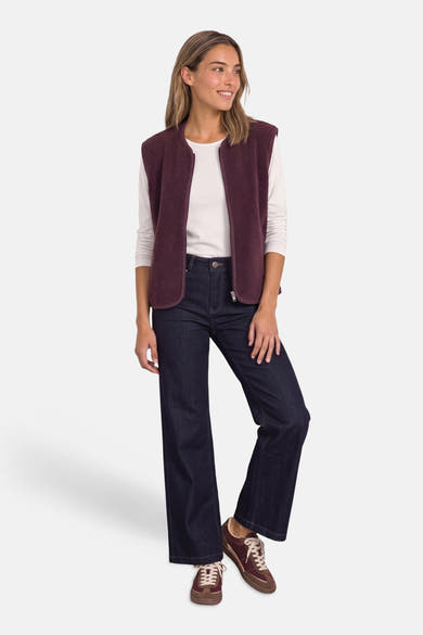 Gilet bordeaux en tissu doux par STREET ONE, porté avec un haut blanc, jeans larges et baskets marron, vue de face.