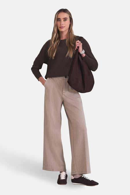 Pull à col rond brun de STREET ONE, porté avec un pantalon à chevrons et des chaussures de sport.
