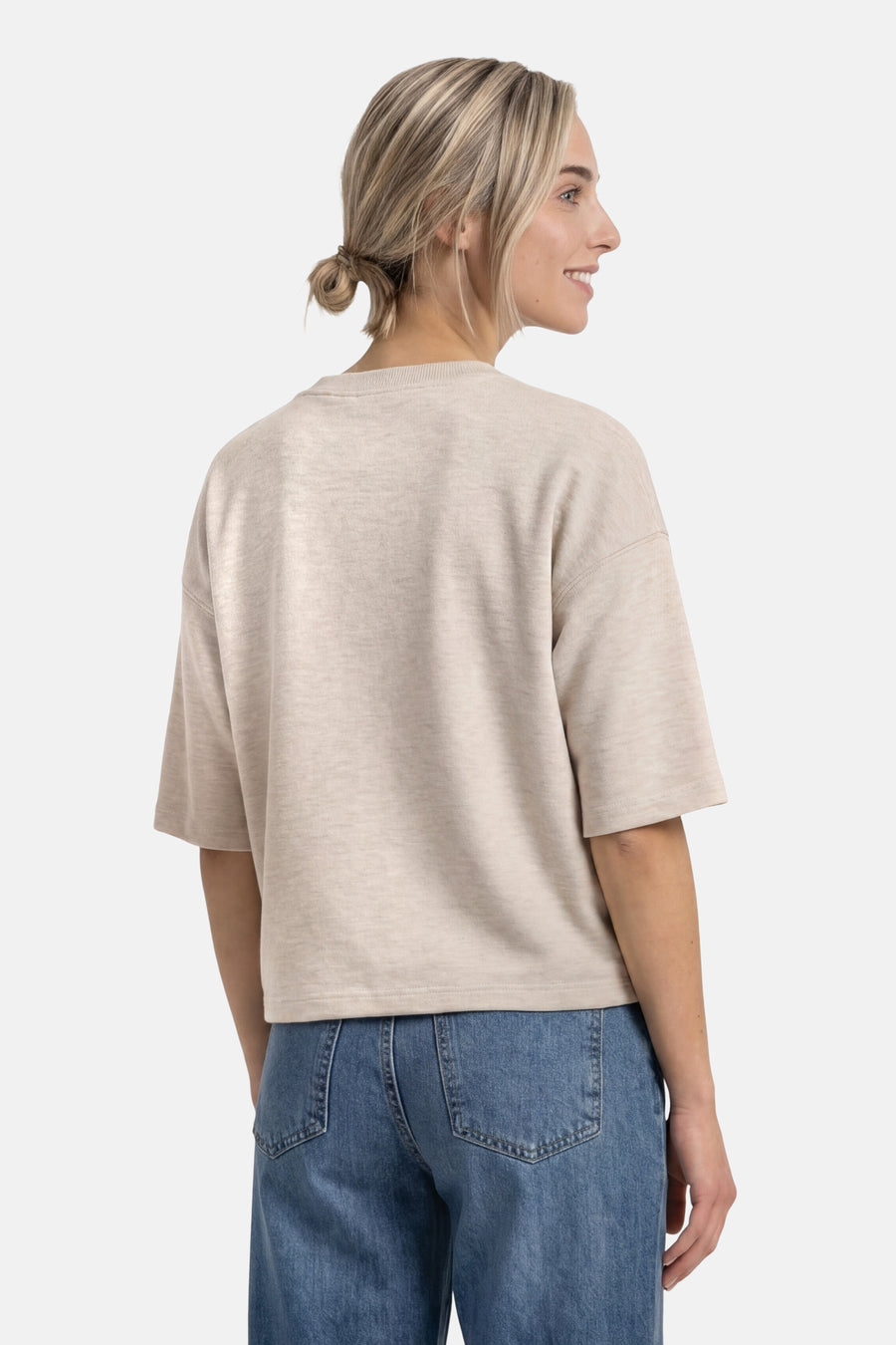 Beige crewneck sweatshirt with relaxed fit and short sleeves, back view on model wearing blue jeans