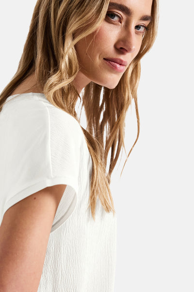 Top uni manches courtes blanc de STREET ONE, texture gaufrée discrète, porté par une femme blonde.
