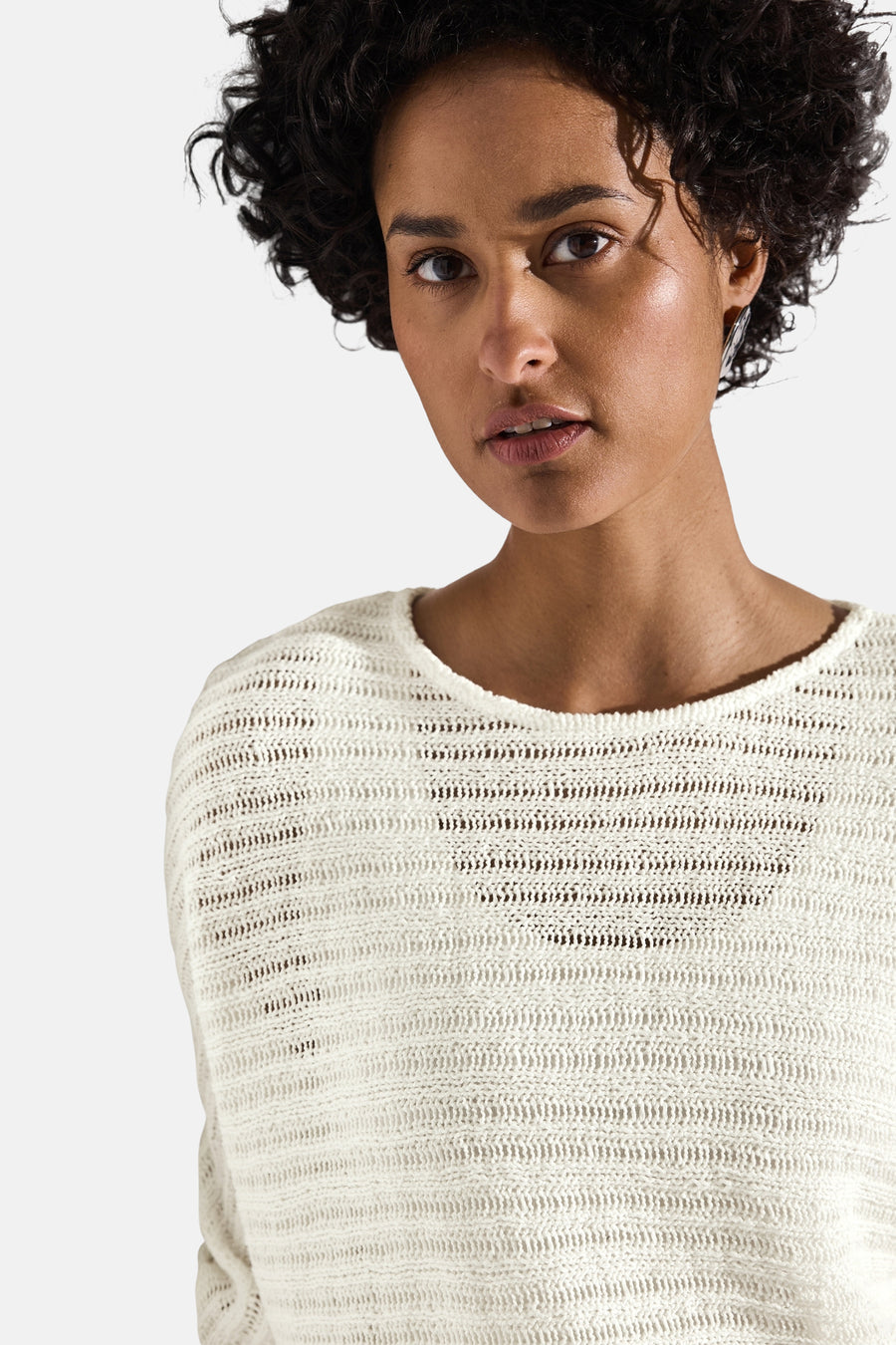Pull col rond blanc de Street One, en maille ajourée avec une femme au teint mat.