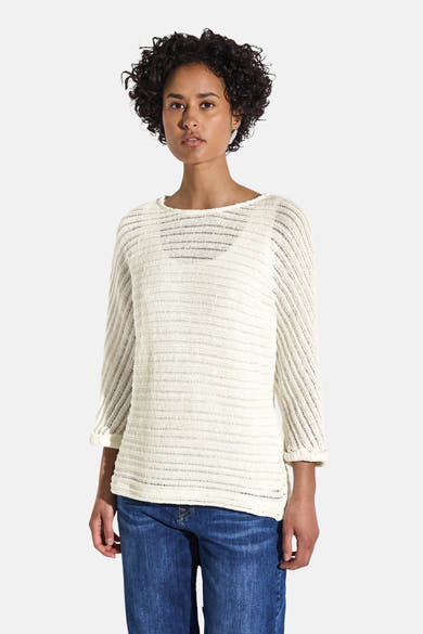 Pull col rond blanc par Street One, avec une texture tricotée ajourée, porté avec un jean bleu.
