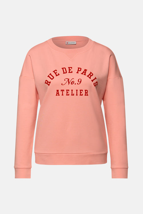 Sweat col rond corail de Street One, imprimé avec texte rouge "Rue de Paris".
