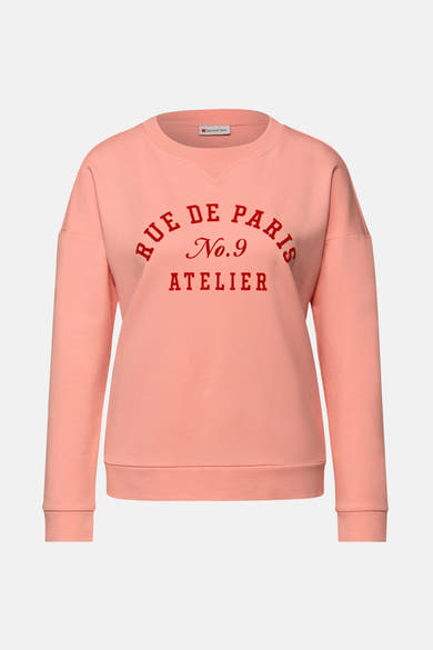 Sweat col rond corail de Street One, imprimé avec texte rouge "Rue de Paris".
