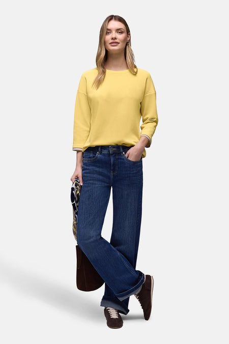 Sweat jaune de STREET ONE, manches trois-quarts avec bordure rayée, porté avec un jean ample et des chaussures marron.