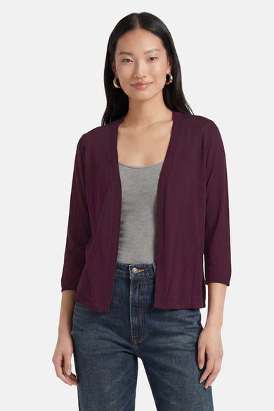 Bordeaux open-front gilet with three-quarter sleeves and ribbed trim, worn over gray top and blue jeans, front view