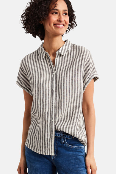Multicolored short-sleeve striped blouse with button front, worn with blue jeans, front view