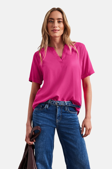 Blouse rose à manches courtes de STREET ONE avec un col en V, portée avec un jean bleu et un sac marron.