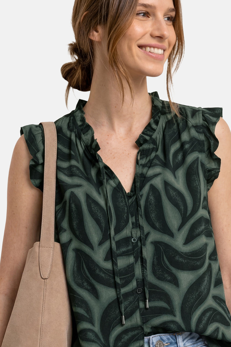 Green sleeveless blouse with leaf pattern and ruffled shoulders by STREET ONE, worn with a beige tote bag, front view.