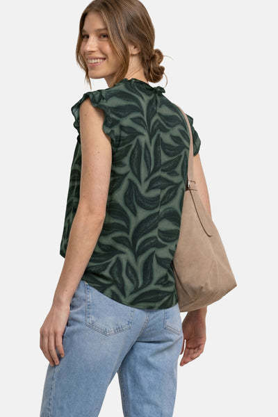 Green sleeveless blouse with leaf pattern by STREET ONE, ruffled shoulders, worn with light blue jeans and beige tote bag, side view